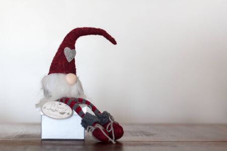 Christmas gnome sitting on top of giftの写真素材