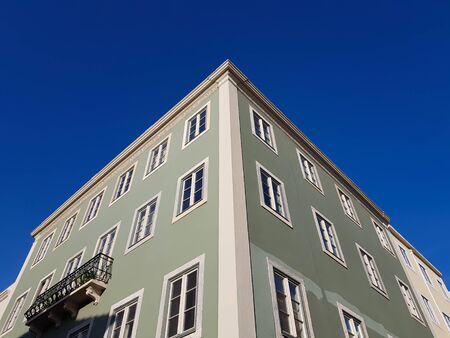 Building facade corner against blue skyの写真素材