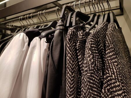 Clothes for sale in a boutique storeの写真素材