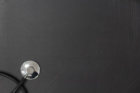 Top view of medical stethoscope on blackboard with copy spaceの写真素材