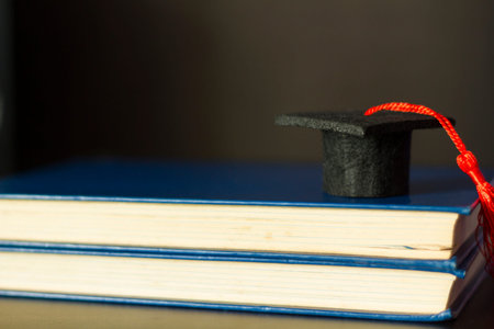 Graduation cap on top of books. Education and Graduation concept