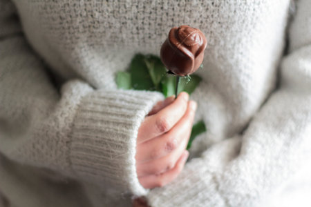 Woman holding chocolate rose. Valentine's day concept