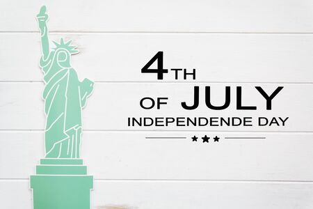 Statue of liberty on white wooden table with the text 4th of July,Independence dayの写真素材