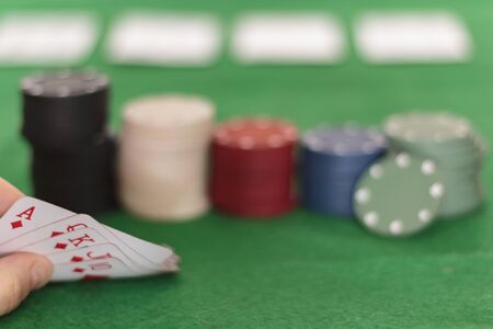 Poker player looking at cards. Winning poker hand royal flushの写真素材
