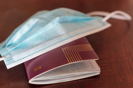 Medical mask and passport.Concept of Traveling during coronavirus, covid-19 pandemicの写真素材