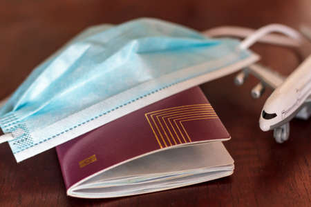 Passport, medical mask and airplane. Concept of Traveling during coronavirus, covid-19 pandemicの写真素材