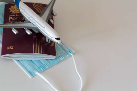 Passport, medical mask and airplane. Concept of Traveling during coronavirus, covid-19 pandemicの写真素材