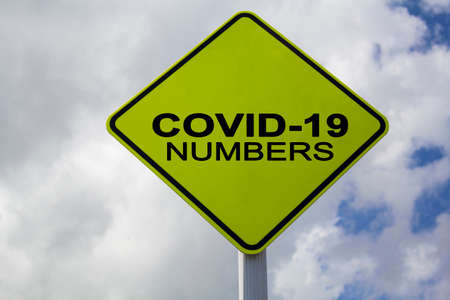 Yellow Sign with Covid-19 textの写真素材