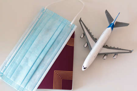 Top view of Passport, medical mask and airplane. Travel during Coronavirus conceptの写真素材