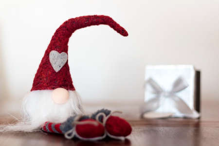 Christmas gnome with gift box on the backgroundの写真素材