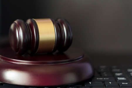 Judge's gavel on computer keyboard. Cyber crime, law and justice conceptの写真素材