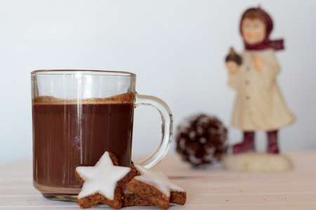 Hot chocolate and cookies with pine cone and winter doll on the background. Winter conceptの写真素材