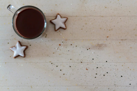 Top view of hot chocolate and star-shaped cookies. With copy space