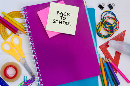 Top view of school supplies with Back to School text on yellow sticker paperの写真素材