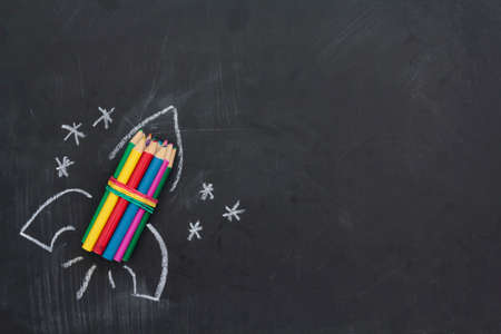 Hand drawn rocket on chalkboard. Top view with copy space. Back to school conceptの写真素材