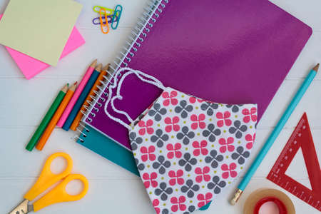 School supplies and cloth face mask. Back to school during covid-19 pandemic, new normal conceptの写真素材