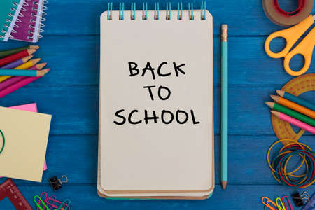 Top view of school supplies and notepad with the text Back to schoolの写真素材