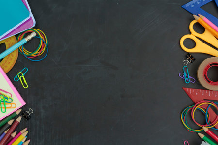 Top view of school supplies on chalkboard with copy space. For background use. Back to school...