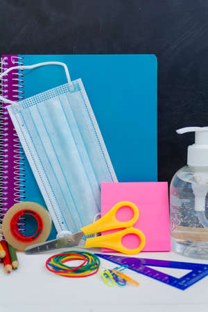 School supplies, protective face mask. Back to school during covid-19 pandemic, new normal conceptの写真素材
