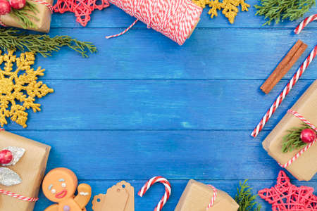 Christmas decoration full borders on blue wooden table with copy space. Christmas backgroundの写真素材