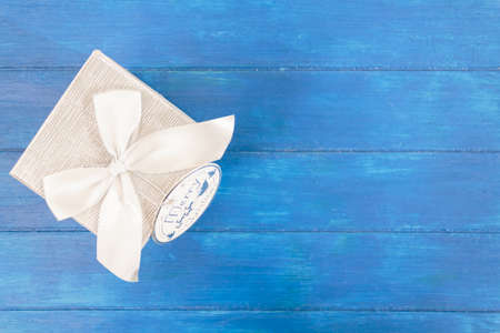 Top view of gift box on blue wooden background with copy spaceの写真素材