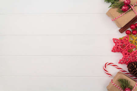 Christmas background with decoration on side border on white wooden table. Top view with copy spaceの写真素材
