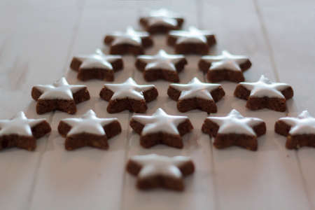 Christmas tree made with heart shaped cookies on white wooden tableの写真素材