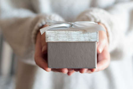 Woman hands holding a gift boxの写真素材