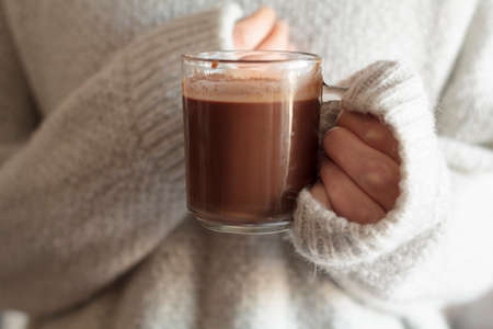 Girl holding a cup of hot chocolateの写真素材