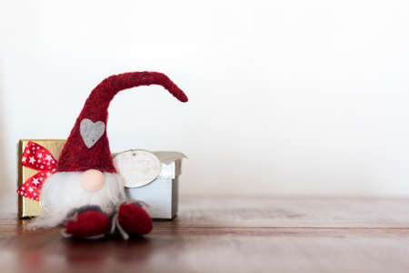 Christmas gnome and gifts on wooden table with copy spaceの写真素材