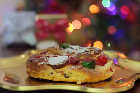 Traditional Christmas cake or King's Cake with christmas tree on the backgroundの写真素材