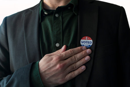 Patriotic man with usa I Voted today sticker in his suit touching hand on his chest