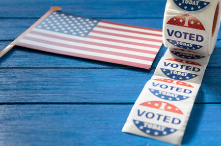 I Voted Today sticker with USA flag on blue wooden table. US presidential electionの写真素材