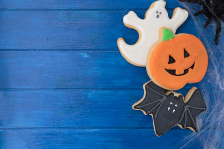 Halloween cookies on blue wooden table. Top view with copy spaceの写真素材