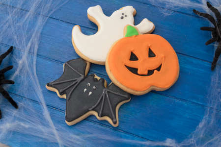 Halloween cookies on blue wooden tableの写真素材