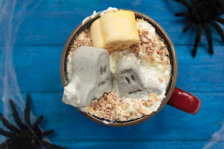 Top view of mug with halloween hot drink with whipped cream and marshmallowsの写真素材