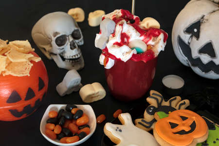 Halloween party table with treats and scary decorationの写真素材