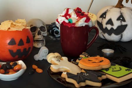 Halloween table with variety of treats and snacksの写真素材