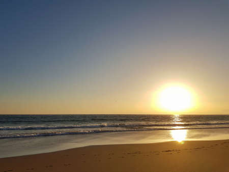 Ocean beach at sunsetの写真素材