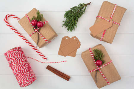 Top view of homemade christmas presents and christmas decoration on white wooden tableの写真素材
