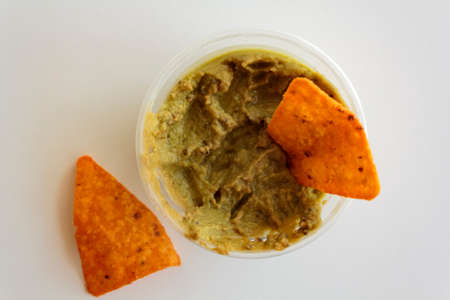 Top view of guacamole with nachos on white backgroundの写真素材
