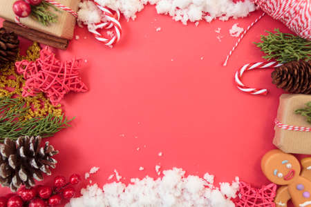 Top view of christmas decoration and snow on red background with copy space. Christmas backgroundの写真素材