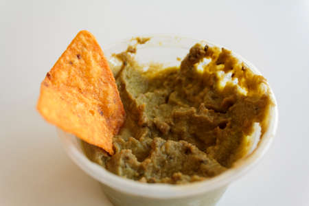 Guacamole with nachos on white backgroundの写真素材
