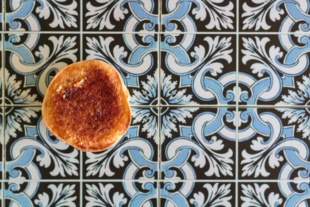 Traditional portuguese sweet cake called Queijadas de Sintra on portuguese tiles background