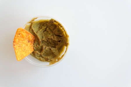 Top view of guacamole with nachos on white background with copy spaceの写真素材
