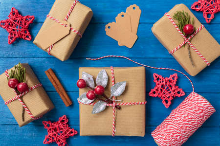 Top view of homemade christmas presents and christmas decoration on blue wooden tableの写真素材