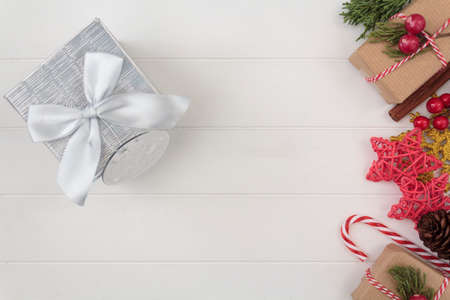 Top view of gift box and Christmas decoration on white wooden table. Top view with copy spaceの写真素材
