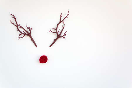 Christmas reindeer concept with red nose and antlers on white background with copy spaceの写真素材