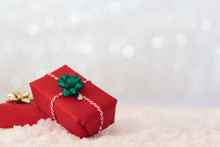 Christmas gifs on snow with shiny background with copy spaceの写真素材