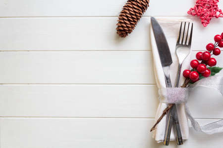 Christmas table setting on white wooden table with copy spaceの写真素材